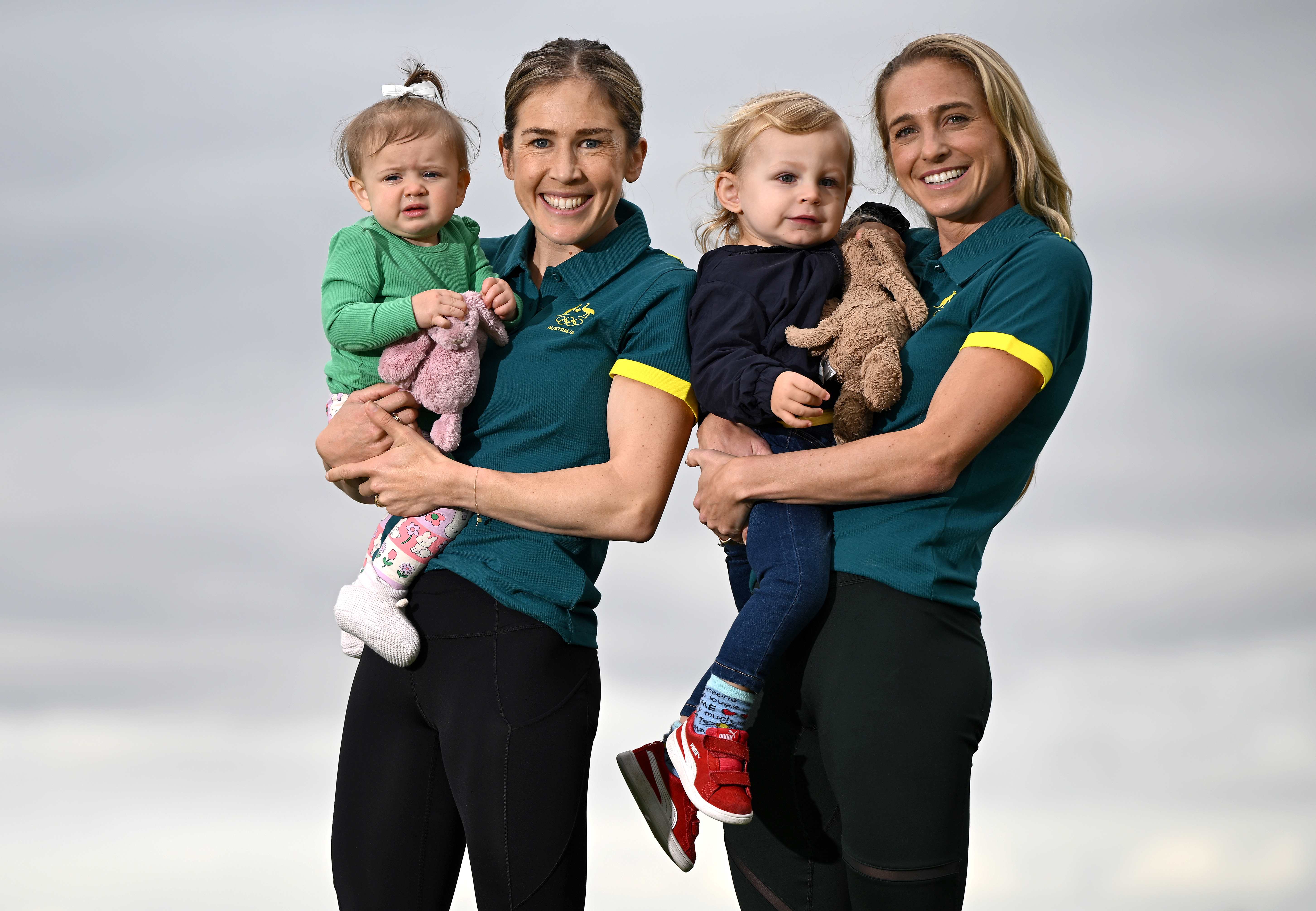 Australian Marathon athletes Jessica Stenson with daughter Ellie Stenson and Genevieve Gregson with son Archer Gregson pose during the Australian 2024 Paris Olympic Games Marathon Team Announcement at Lakeside Stadium on June 03, 2024 in Melbourne, Australia. 